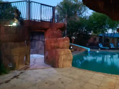 a backyard with a swimming pool and a house at Clyde's on Dale Guest House in Springs