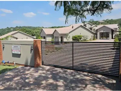 a fence in front of a house at Vaendzi Lodge in Nelspruit