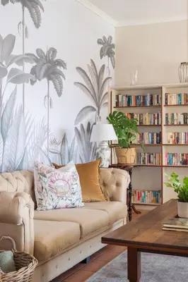 a living room with a couch and a book shelf at House Falcon in Pretoria