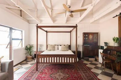 a bedroom with a bed and a ceiling fan at House Falcon in Pretoria