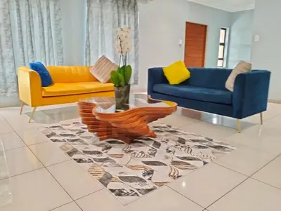a living room with two couches and a table at O&S BnB in Centurion