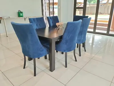a table and chairs with blue chairs around it at O&S BnB in Centurion