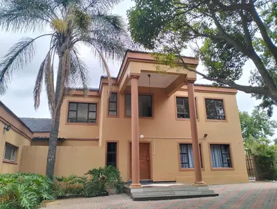 a house with a palm tree in front of it at O&S BnB in Centurion