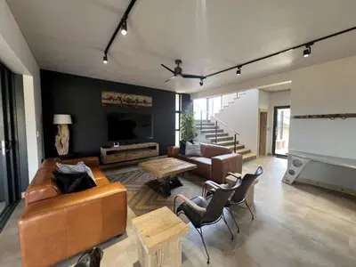 a living room with a couch and a table at Bluebell House@799 in Dullstroom
