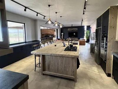 a large kitchen with a large island in the middle at Bluebell House@799 in Dullstroom