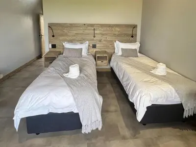 two beds sitting next to each other in a bedroom at Bluebell House@799 in Dullstroom