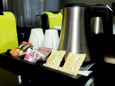a tray with a tea kettle on a table at Q's Evander Hotel & Apartments in Evander