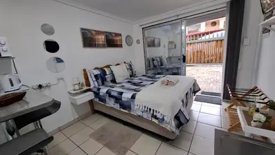 a bedroom with a bed and a sink and a window at Sleep Haven Self-Catering Accommodation - Nelspruit in Nelspruit