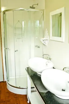 a bathroom with two sinks and a shower at Magoebaskloof Getaway in Magoebaskloof