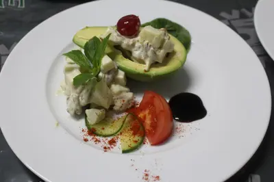a plate of food with avocado and a salad at Magoebaskloof Getaway in Magoebaskloof