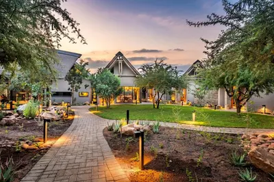 a house with a garden in front of it at Marula Sunrise Lodge, Mjejane Private Game Reserve in Hectorspruit