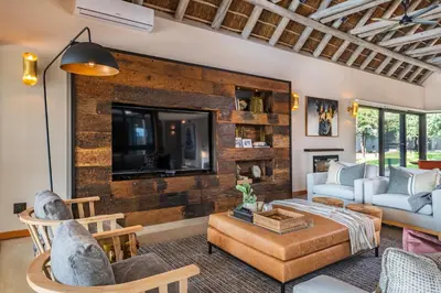 a living room with a brick wall at Marula Sunrise Lodge, Mjejane Private Game Reserve in Hectorspruit