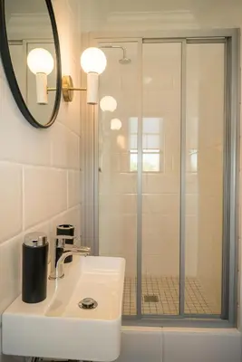 a bathroom with a sink and a shower at The Lofts @ Maple Square in Dullstroom