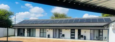 a building with solar panels on the roof at TrendyBliss Guest House in Northam