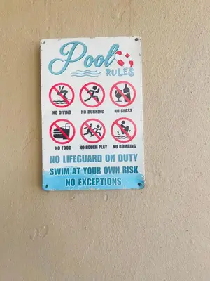 a sign on a wall that says no dogs and no exceptions at TrendyBliss Guest House in Northam