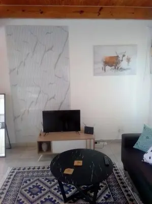 a living room with a couch and a table at Anglerfish in Centurion