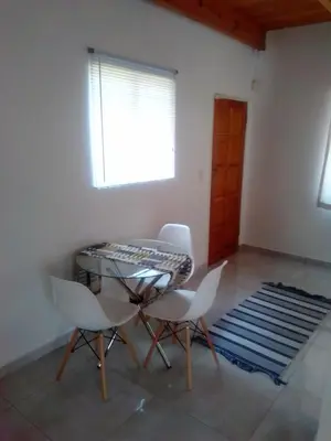 a dining room with a glass table and white chairs at Anglerfish in Centurion