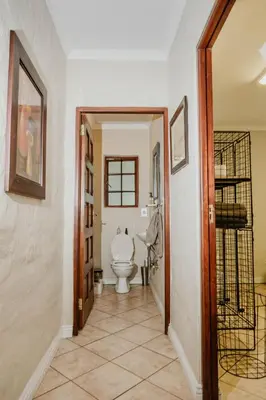 a bathroom with a toilet in a hallway at Filmerton Country Lodge in Kyalami
