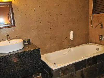 a bathroom with a sink and a bath tub at 2Ten Hotel in Sibasa
