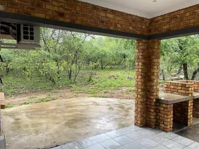a brick patio with a view of a field at 2998 on Olifant in Marloth Park