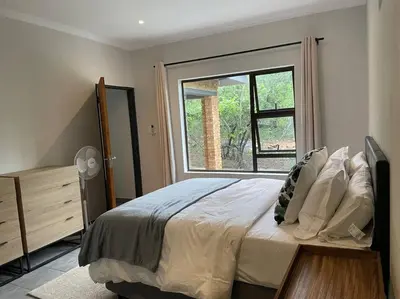 a bedroom with a large bed and a window at 2998 on Olifant in Marloth Park