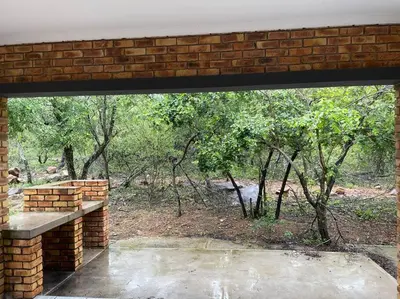 a brick building with a window looking at a river at 2998 on Olifant in Marloth Park