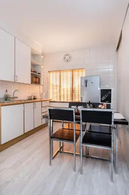 a kitchen with a table and two chairs in it at Fralande Self Catering Units in Pretoria