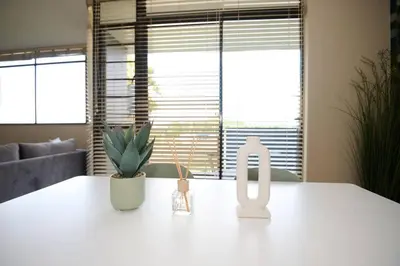 a kitchen with a white counter top with a window at Unit 406 at Menlyn Place in Pretoria