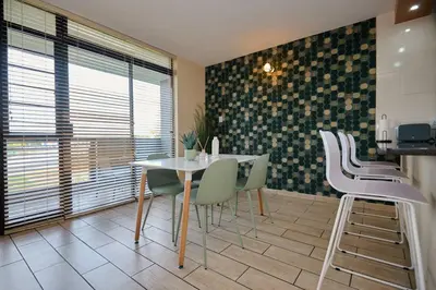 a dining room with a table and chairs at Unit 406 at Menlyn Place in Pretoria