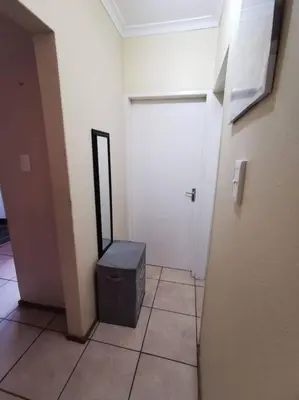 a hallway with a room with a door and a trash can at Apartment@VillaVel in Midrand