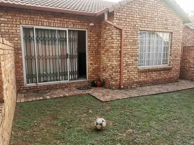 a soccer ball on the grass in front of a house at Apartment@VillaVel in Midrand