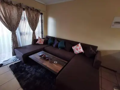 a living room with a couch and a coffee table at Apartment@VillaVel in Midrand