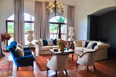 a living room with two couches and a table at Ambonnay Terrace Guest House in Pretoria