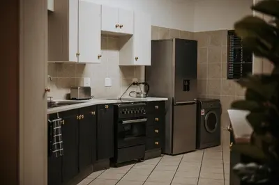 a kitchen with black cabinets and a dishwasher at @Kruger in White River
