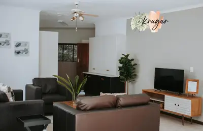 a living room with a couch and a tv at @Kruger in White River