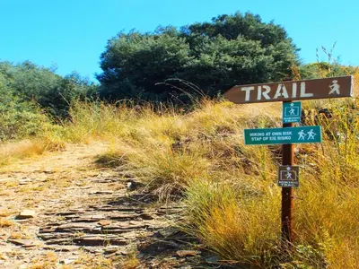 a trail sign on the side of a dirt trail at Incwala Lodge in Waterval Boven