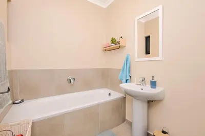 a bathroom with a sink and a bath tub and a toilet at Michelle's Hospitality Hub in Midrand