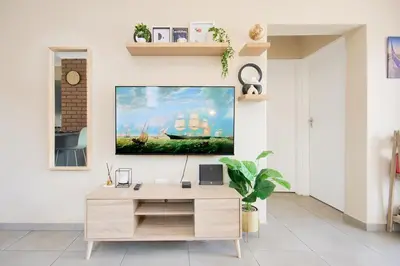 a living room with a tv on a wall at Michelle's Hospitality Hub in Midrand