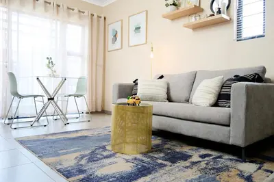 a living room with a couch and a table at Michelle's Hospitality Hub in Midrand