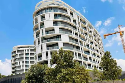 a tall white building with a crane in front of it at Newton’s Place - Luxury styled 2 BD Apartment in Midrand