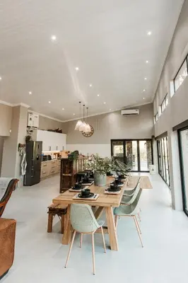 a large dining room with a wooden table and chairs at Chawal stays @ Leguan in Marloth Park