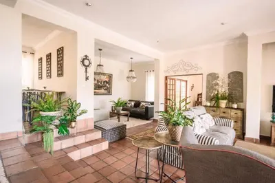 a living room with a couch and a table at LilyRose Bed & Breakfast in Pretoria