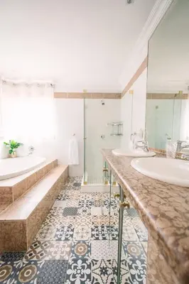 a bathroom with two sinks and two mirrors at LilyRose Bed & Breakfast in Pretoria