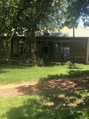 a house with a tree in front of it at Kieron's Cottage in Lydenburg