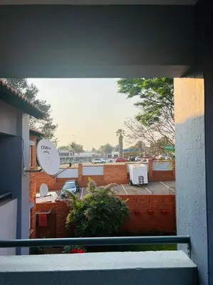 a view of a balcony with a clock on a building at Wanderlust 2-bedroom Apartment in Centurion