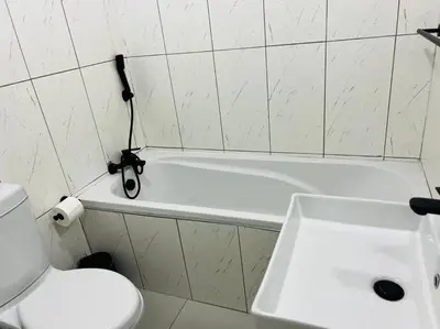 a bathroom with a sink and a white bath tub at Wanderlust 2-bedroom Apartment in Centurion