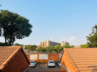 a group of cars parked in a parking lot at Wanderlust 2-bedroom Apartment in Centurion
