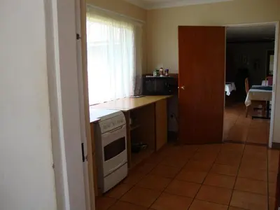 a kitchen with a stove and a counter top at Gateway Guesthouse in Benoni