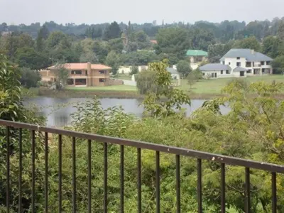 a view of a river from a balcony of a house at Gateway Guesthouse in Benoni