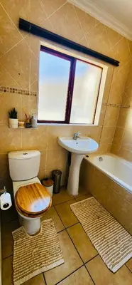 a bathroom with a toilet and a sink at A Warm 3 bed Townhouse in a secure complex in Witbank